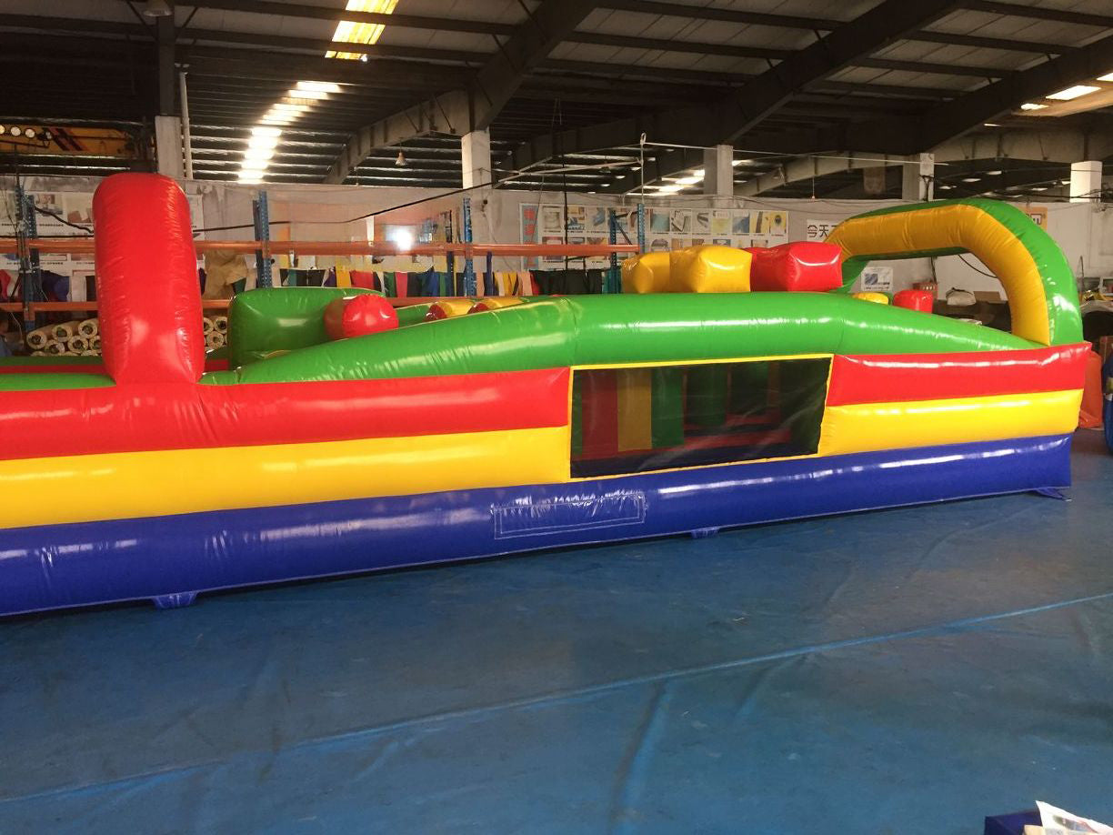 Giant commercial inflatable obstacle course setup for outdoor events and rentals, featuring tunnels, slides, and climbing walls — built with durable Plato PVC.