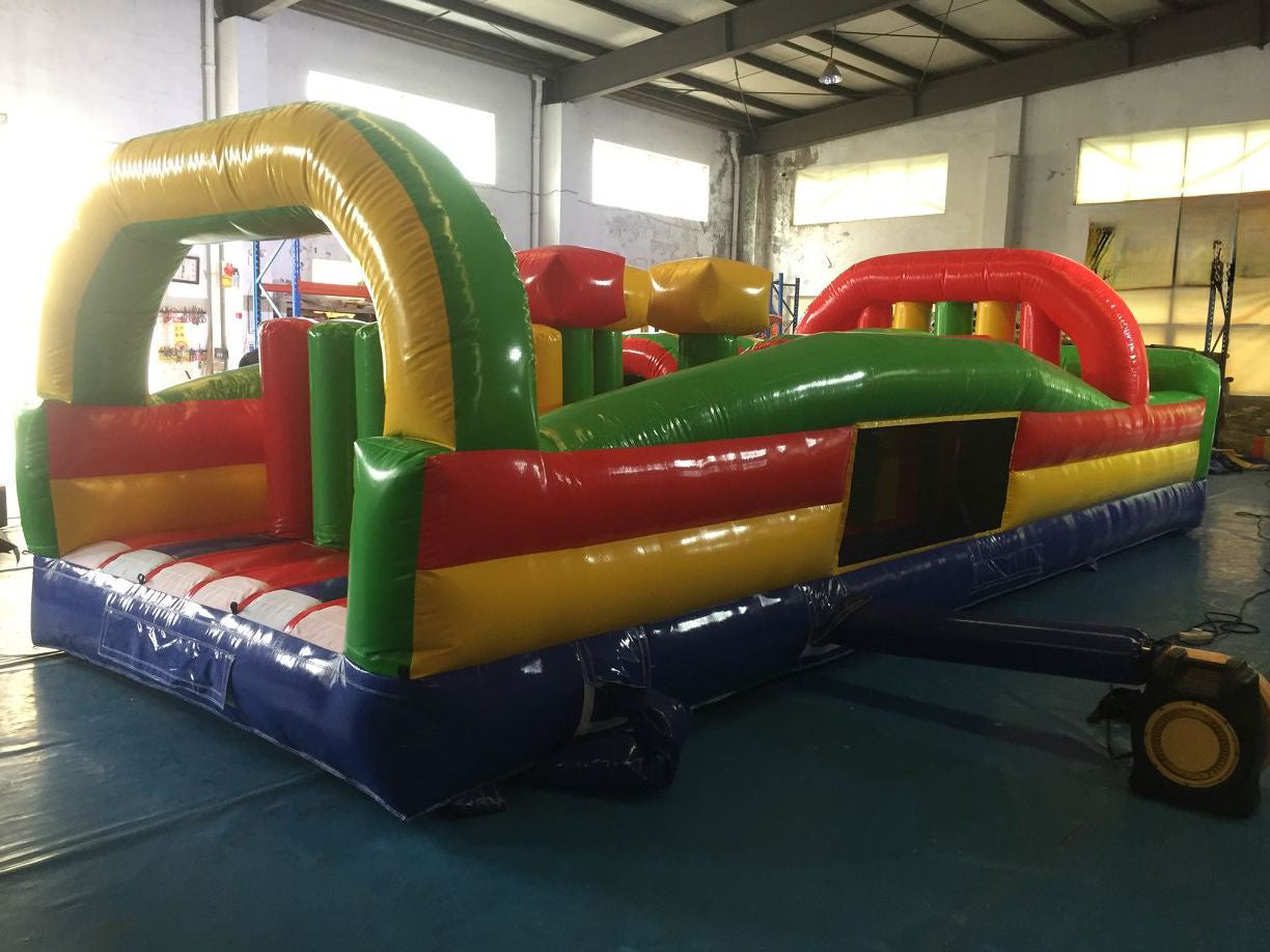 Giant commercial inflatable obstacle course setup for outdoor events and rentals, featuring tunnels, slides, and climbing walls — built with durable Plato PVC.