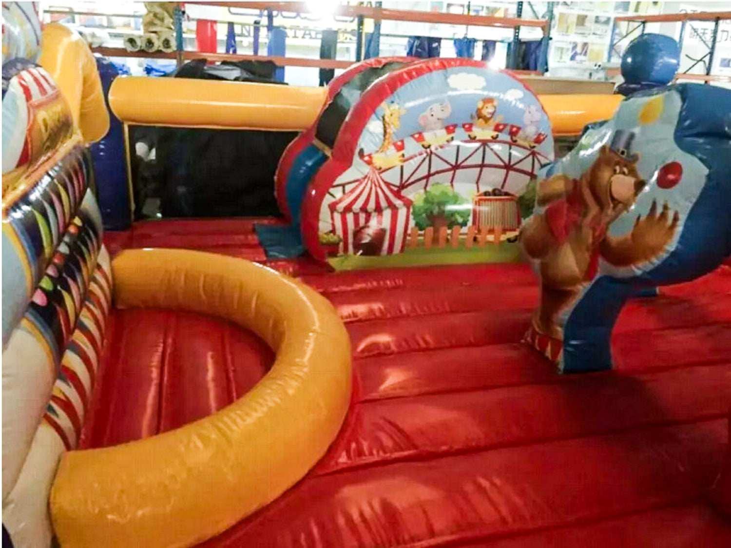 Inflatable playground with colorful design and cartoon character in an indoor setting