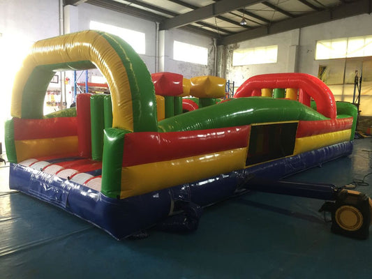 Giant commercial inflatable obstacle course setup for outdoor events and rentals, featuring tunnels, slides, and climbing walls — built with durable Plato PVC.