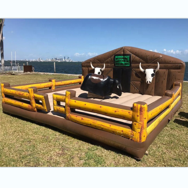 Inflatable mechanical bull riding game with a bull and rider figure, made of commercial grade PVC, requiring a blower for operation.