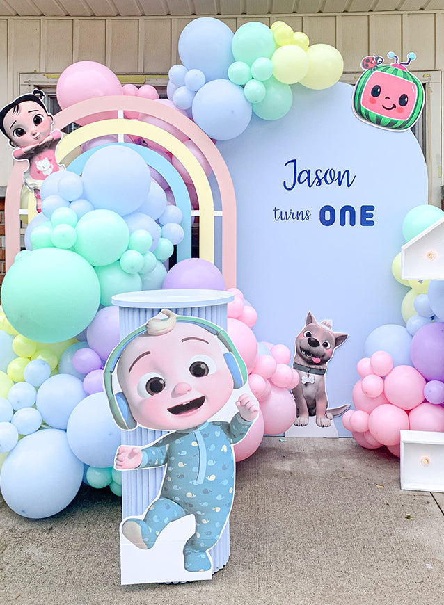 Colorful pre-designed balloon decoration setup with happy birthday sign, cartoon characters, and custom-designed packages for children's birthday party in Toronto